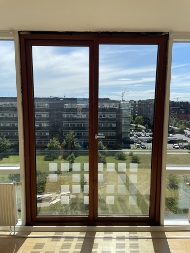 Tømrer udfører tømrerarbejde med montering af døre og vinduer i bolig